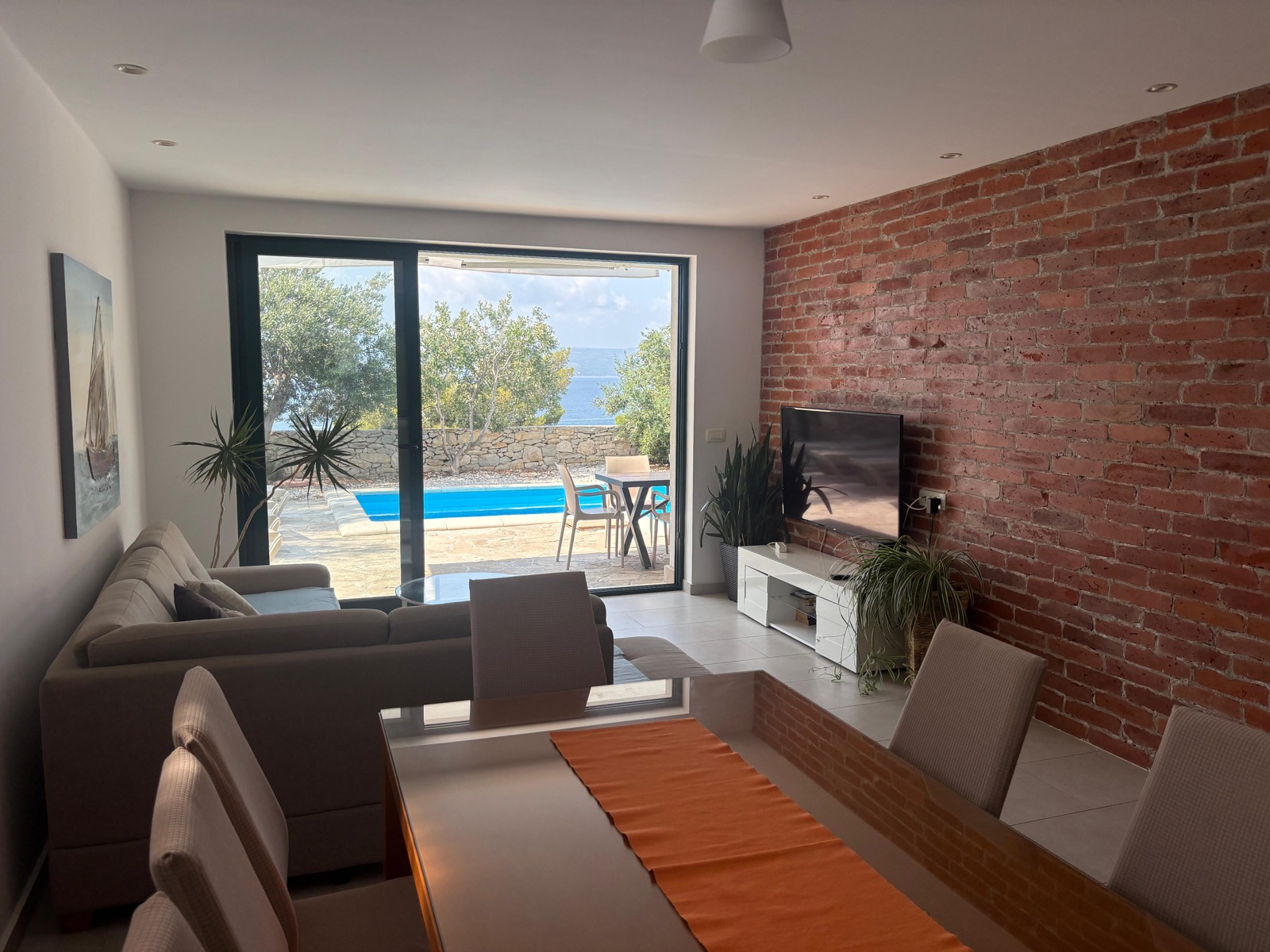 Open-plan living and dining area with new glass dining table